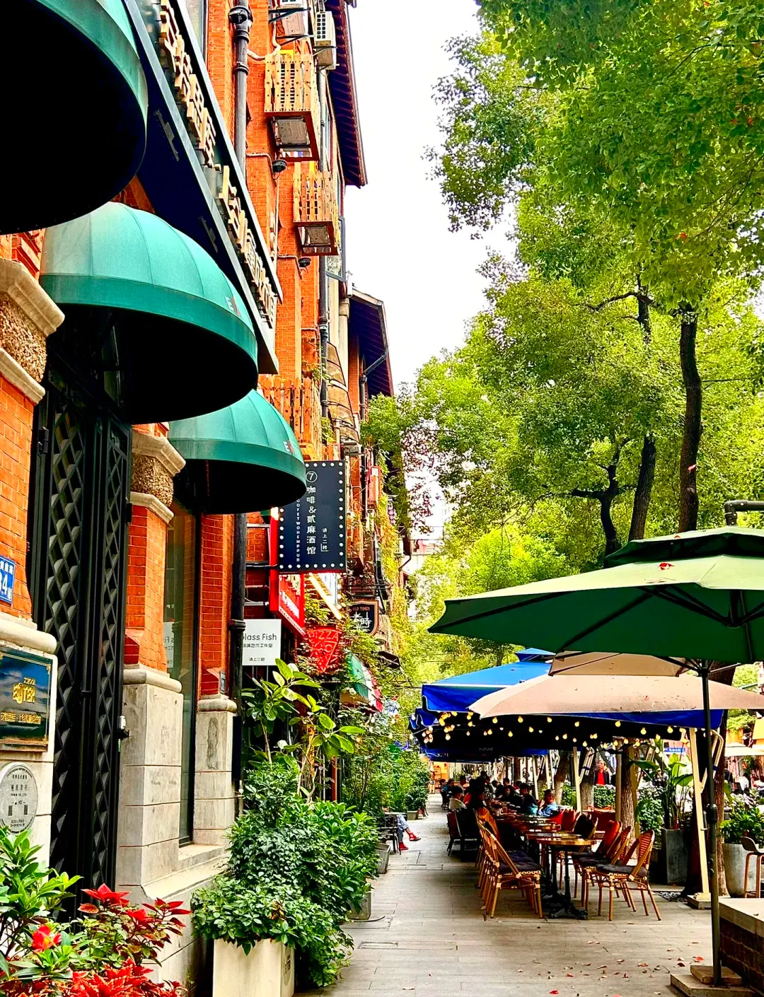 Bars and cafes in renovated 1920s buildings along Lihuangpi Road in Hankou, Wuhan, with warm outdoor lighting