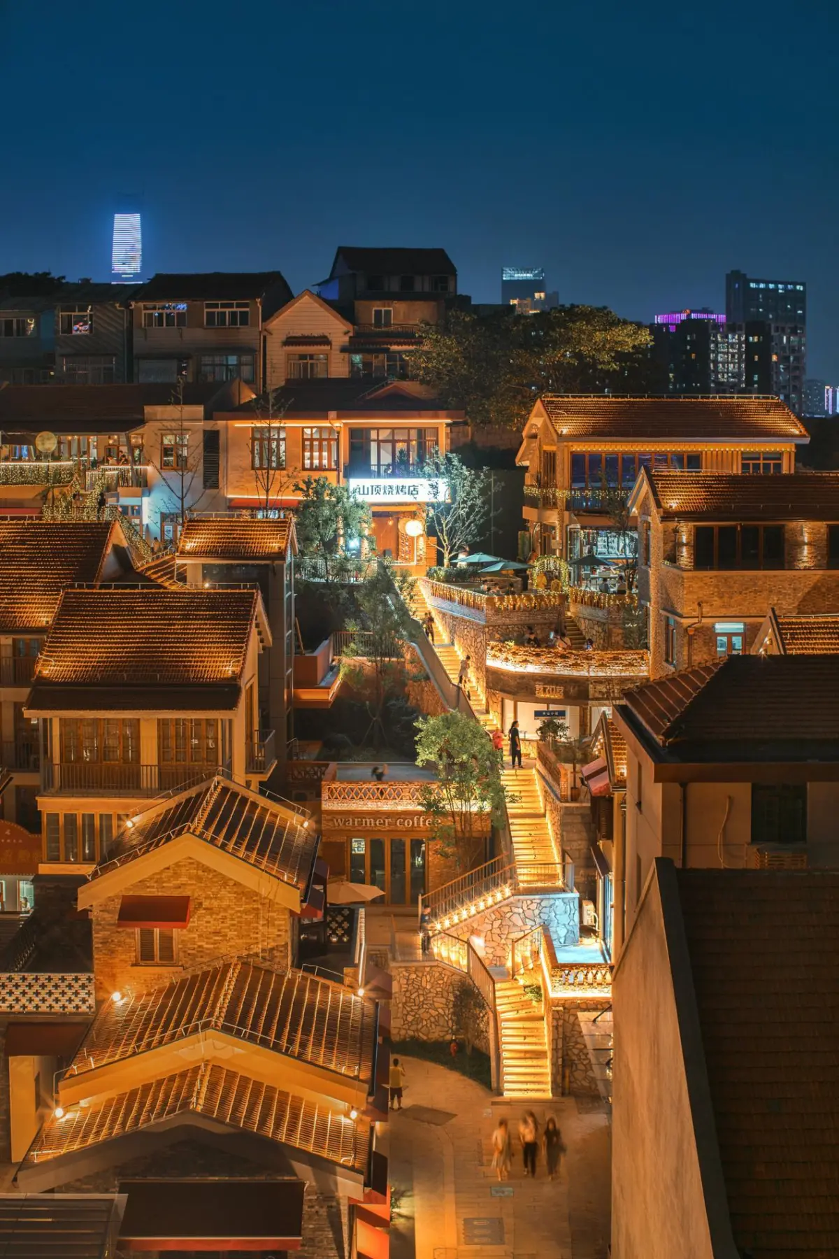 Small bars and cafes along narrow Tanhualin street in Wuchang, Wuhan, with young people drinking beer outside
