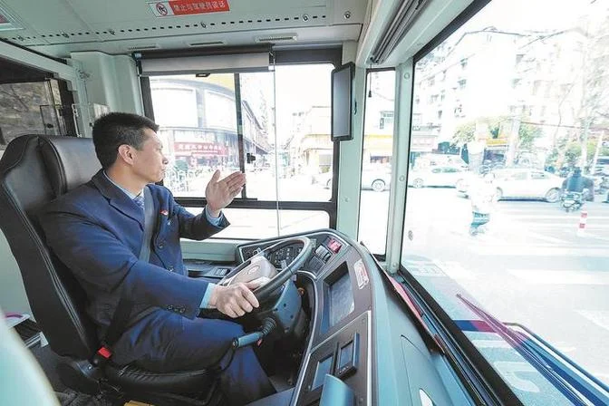 Portrait of a middle-aged Wuhan bus driver at the wheel, focused expression, one hand on the steering wheel, the city reflected in the windshield