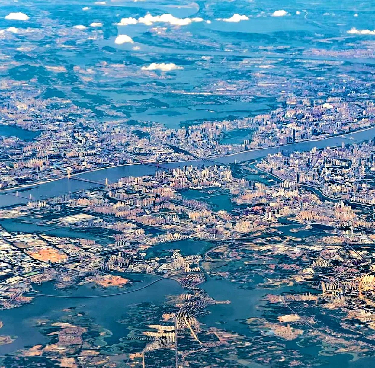 Aerial view of Wuhan's lakes scattered across the urban landscape, showing the contrast between city buildings and large water surfaces