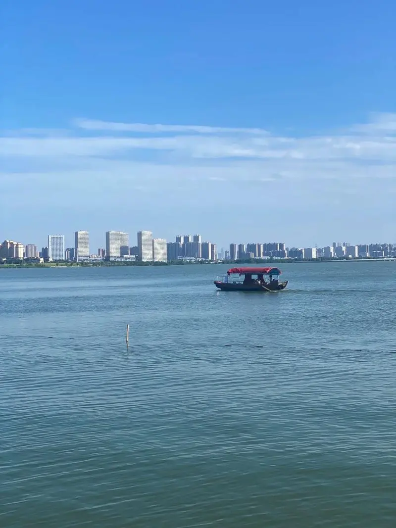 Tangxun Lake in Wuhan, China's largest urban lake by surface area, with calm water and city skyline in the distance