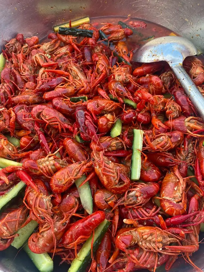 Spicy steamed crayfish pile with Sichuan peppercorn and dried chili on red shells, freshly steamed