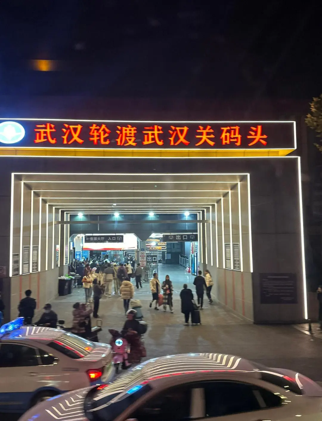 Inside a Wuhan Yangtze ferry cabin with plastic flip-up seats and passengers including elderly shoppers and motorcycle riders