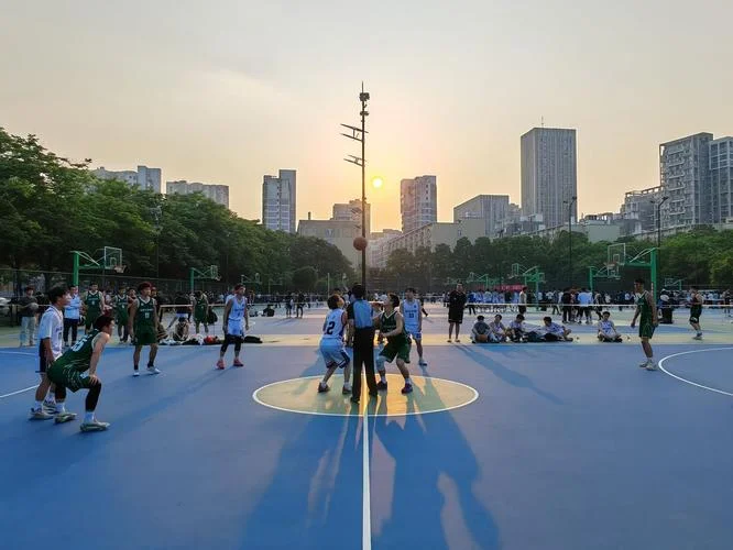 Outdoor basketball court in Wuhan with young people playing pickup games under floodlights in the evening