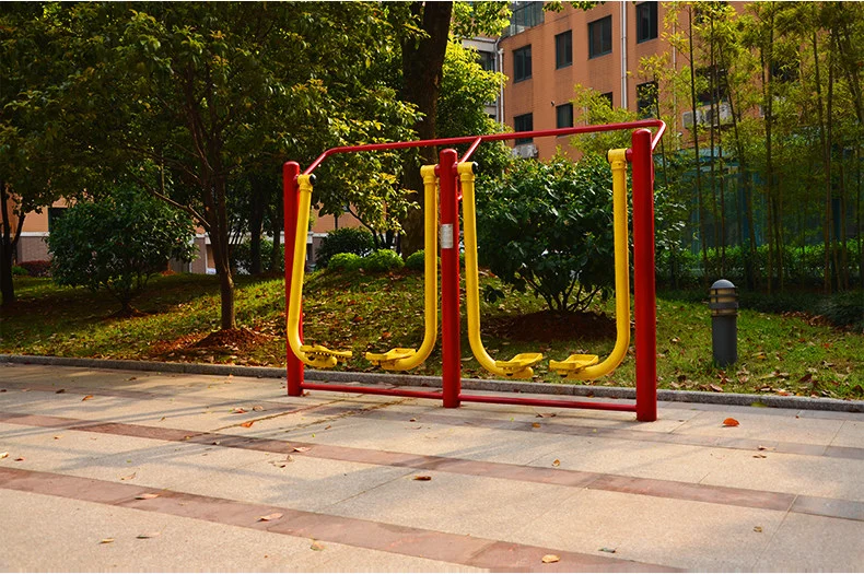 Outdoor fitness equipment in a Wuhan park with senior residents using pull-up bars and stretching apparatus in the early morning