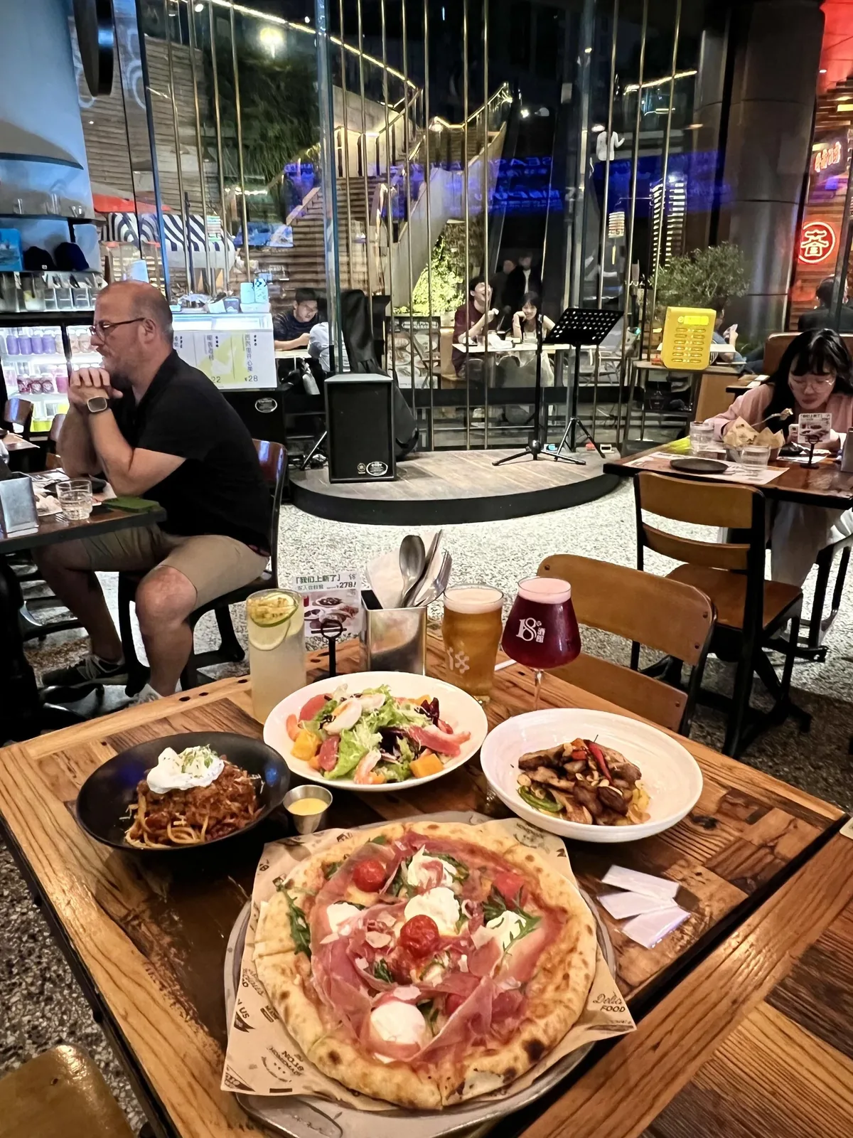 A local Wuhan restaurant or gathering space where foreigners and locals interact, showing the everyday social mixing that defines the city's international community