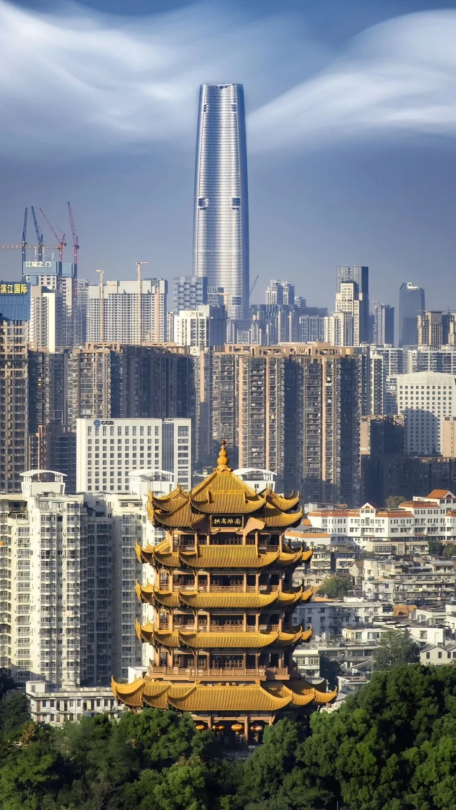 A wide shot of Wuhan's urban landscape blending old and new architecture, representing the city environment where thousands of foreigners have made their home