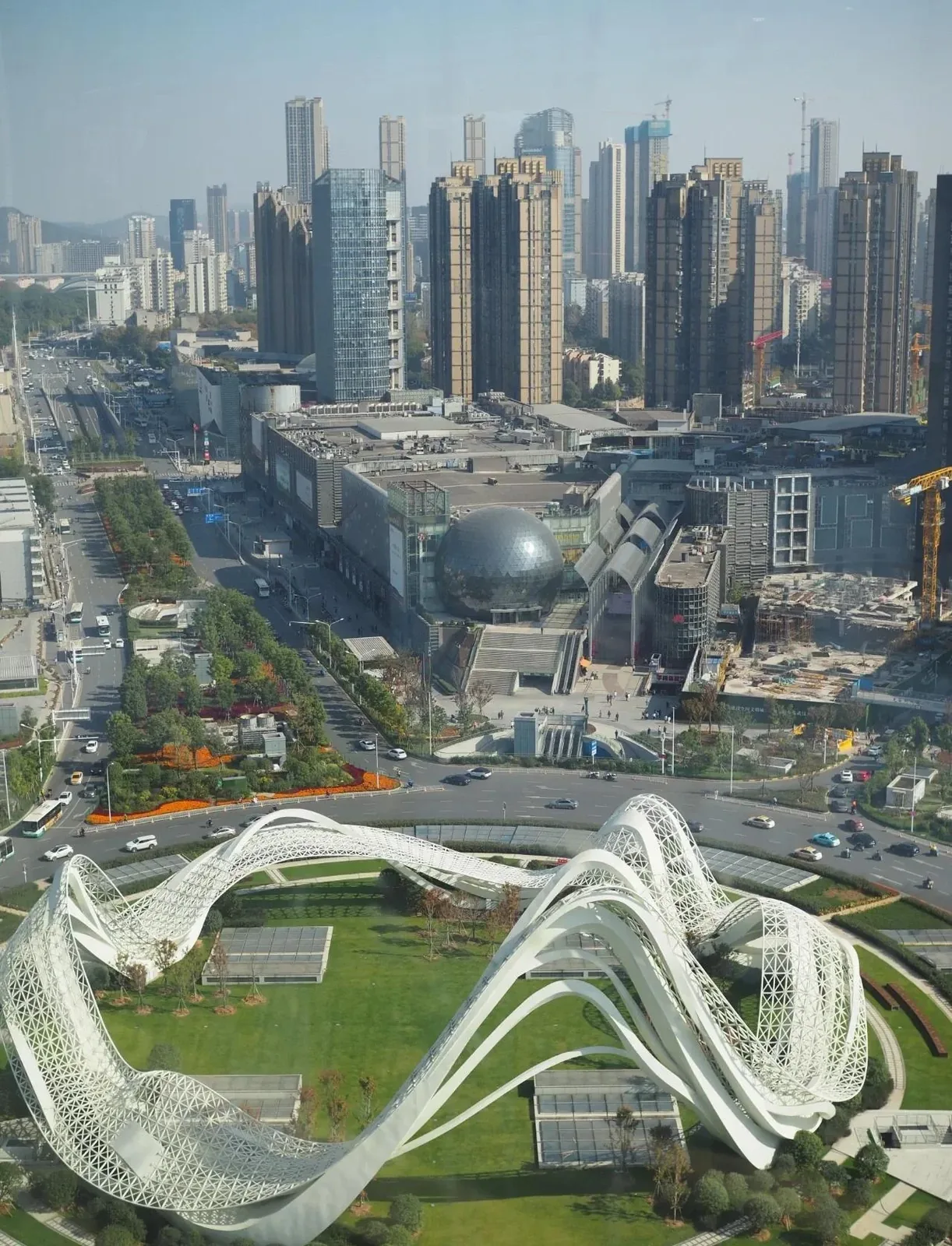 Optics Valley skyline at dusk showing high-rise office buildings and the bustling 光谷步行街