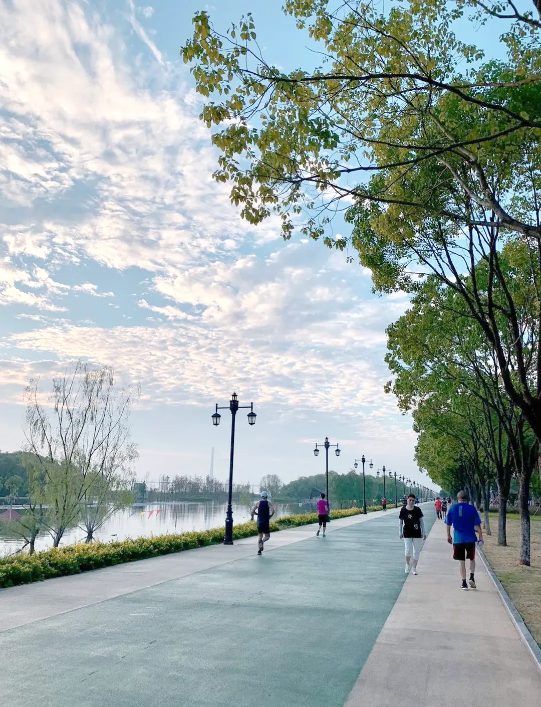 Hankou Riverfront park along the Yangtze at sunrise with locals exercising and walking on the promenade