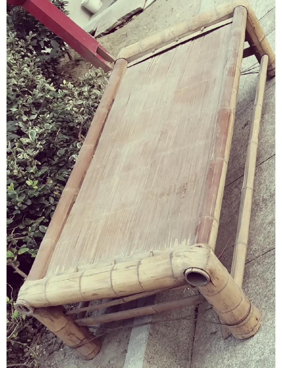 Traditional Chinese bamboo bed used in old Wuhan summers, shown on a street or alleyway where families once slept outdoors to escape the heat