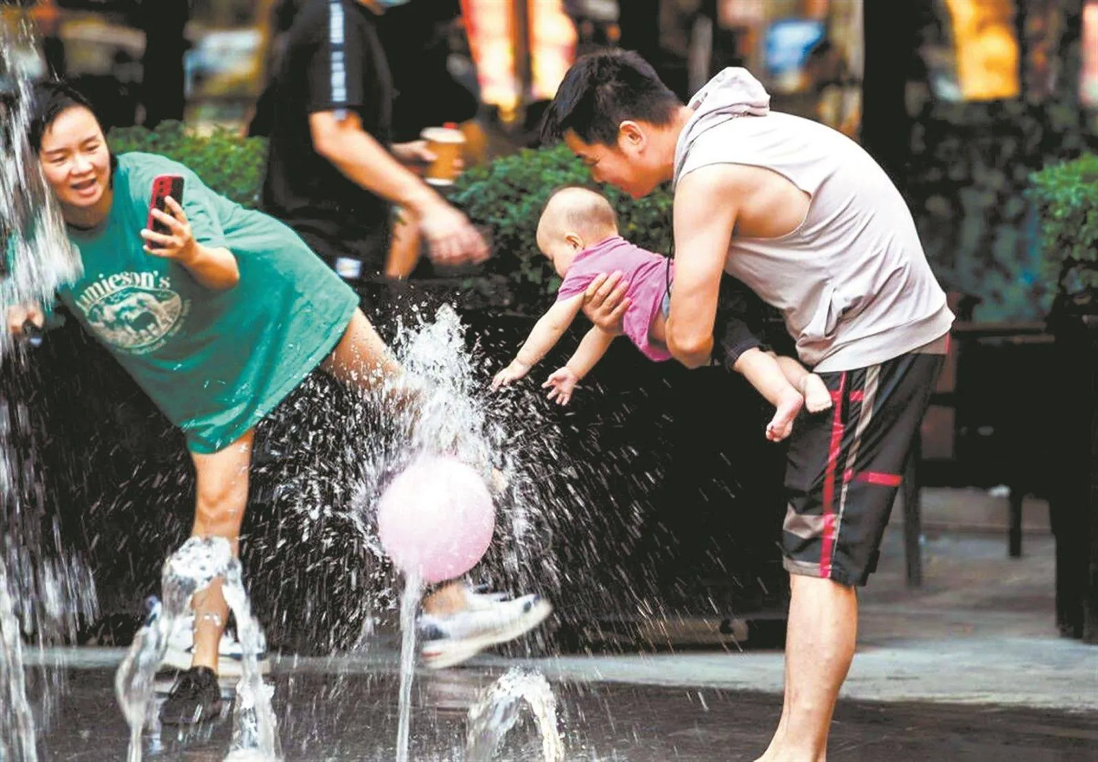 Summer street scene in Wuhan with intense sunlight, pedestrians carrying umbrellas for shade, and heat haze rising from the pavement