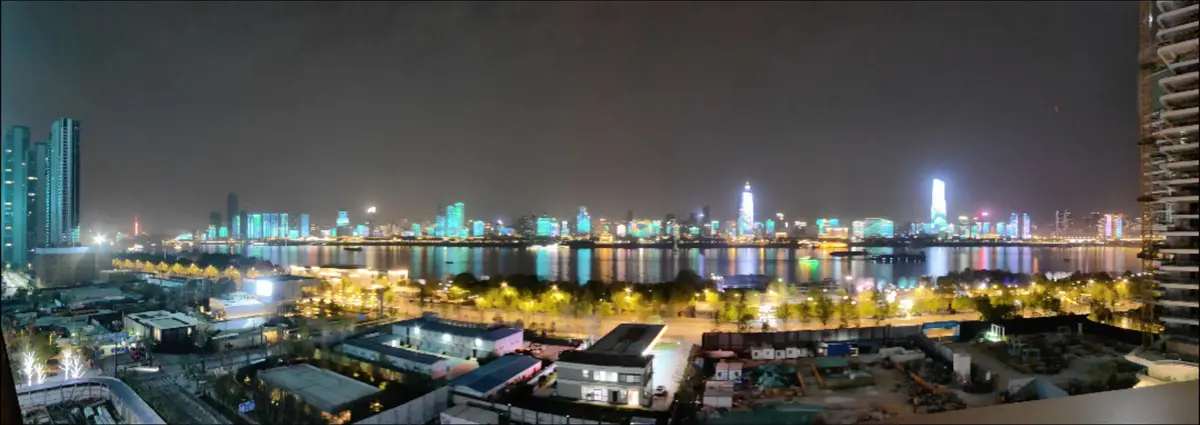 Wuhan city skyline at dusk in summer, showing lights coming on as the city comes alive after the daytime heat subsides