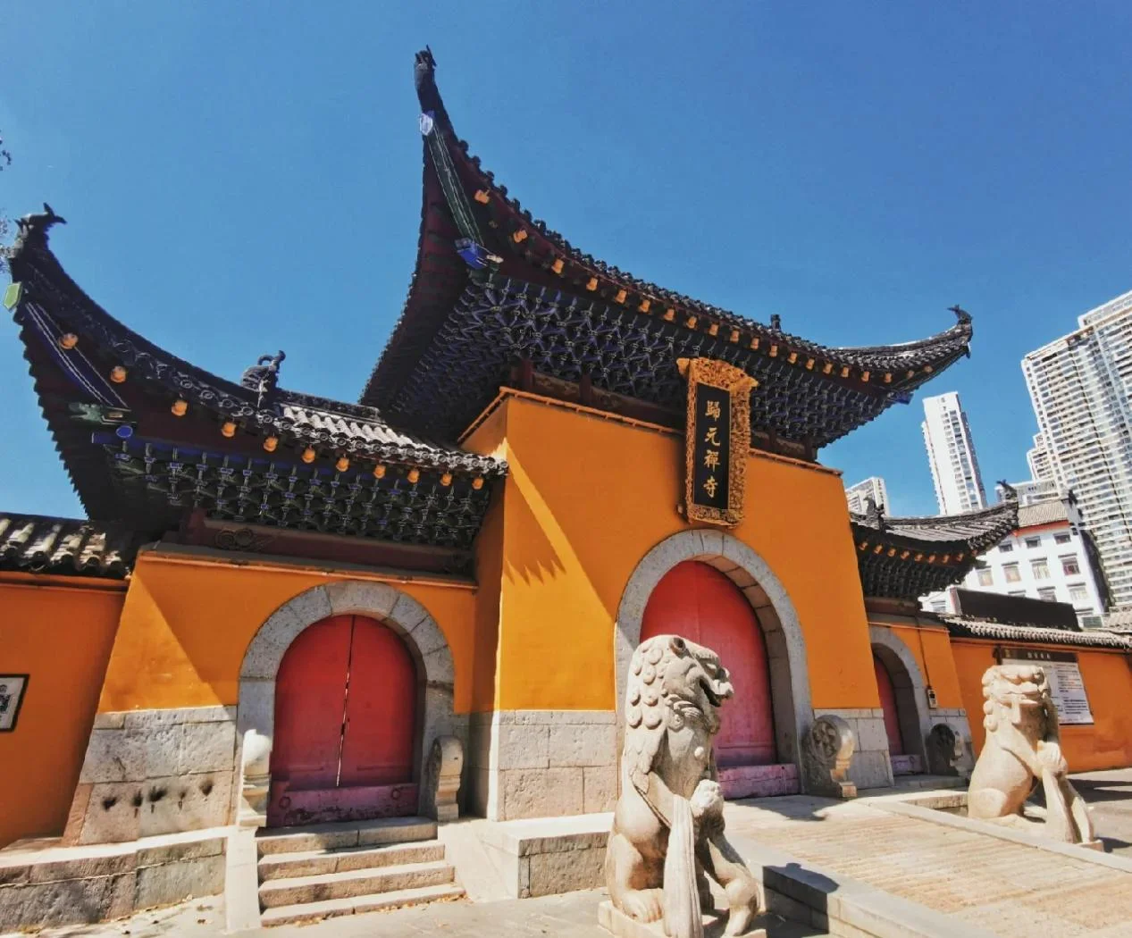 Guiyuan Temple entrance or hall scene: the famous Buddhist temple in Hanyang, with worshippers offering incense beneath ancient eaves, representing Wuhan's most well-known spiritual institution