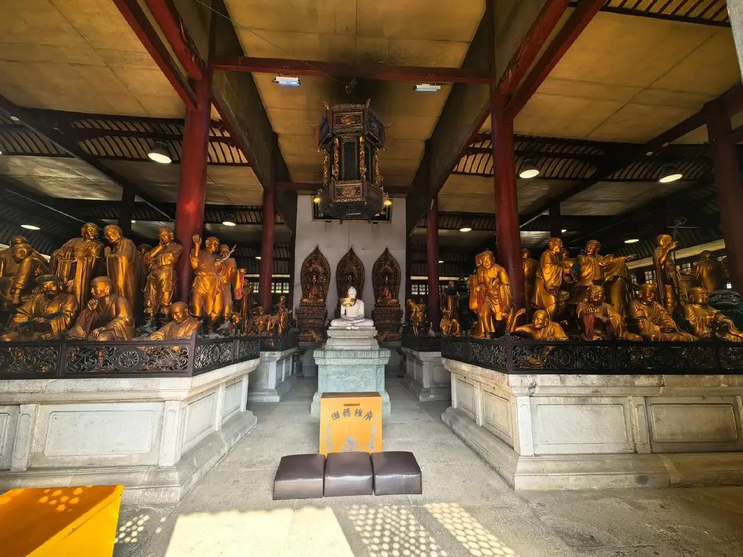 Buddhist temple in Wuhan with incense smoke rising against traditional Chinese architecture with curved eaves and red walls