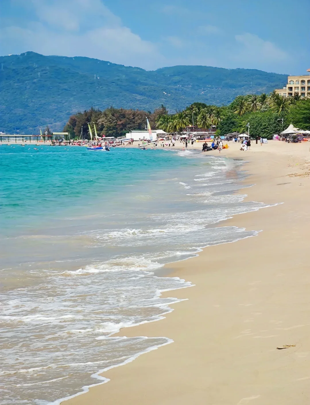 Sanya beach scene: turquoise water, palm trees, Wuhan-accented tourists under umbrellas, winter light, capturing the seasonal migration south that half of Wuhan seems to join
