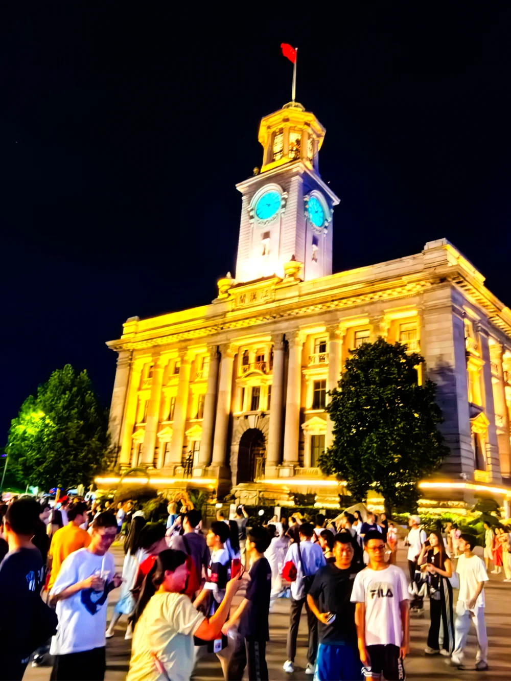 Wuhan weekend night scene: bustling pedestrian street with crowds of young people, neon lights, and lively nightlife atmosphere