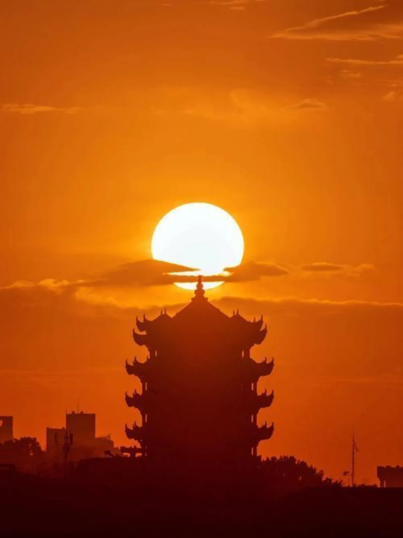 Yellow Crane Tower at sunset in Wuhan, golden light on the pagoda with Yangtze River backdrop